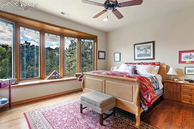 a living room with a bed furniture and a large window