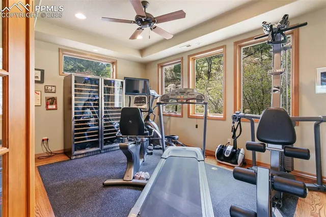 a view of a livingroom with workspace and windows