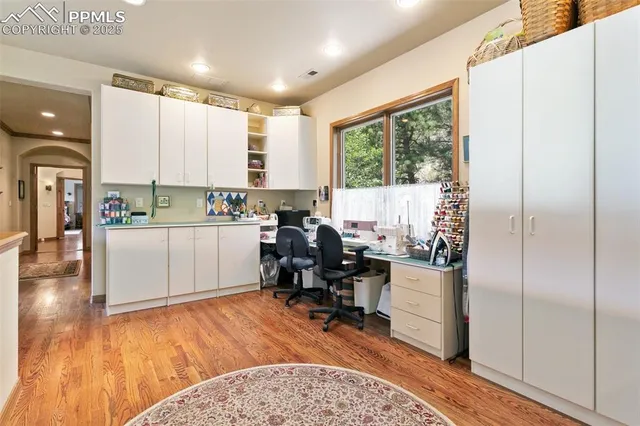 a view of a kitchen with kitchen island granite countertop a refrigerator and a sink
