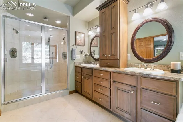 a bathroom with a double vanity sink and a mirror