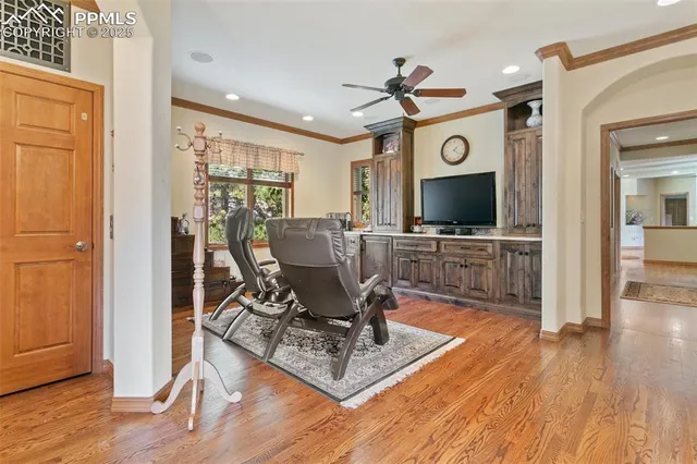 a view of a livingroom with wooden floor and a flat screen tv