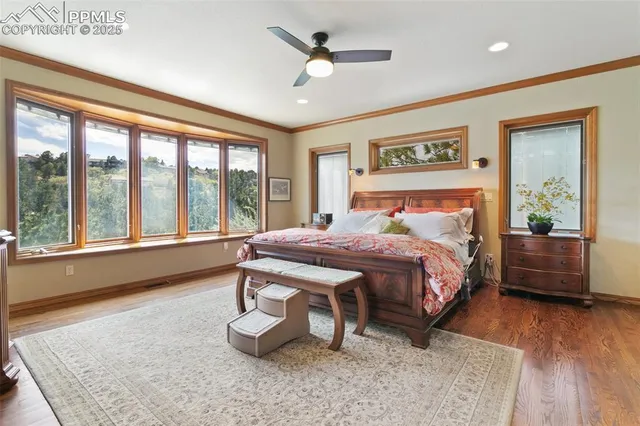 a bedroom with a large bed and a large window