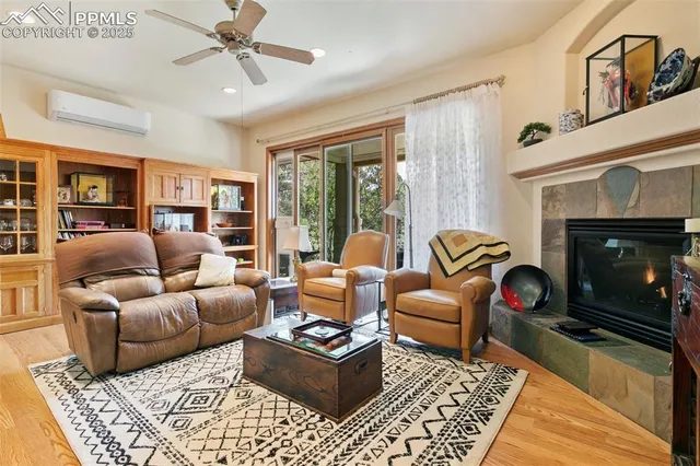 a living room with furniture a fireplace and a table