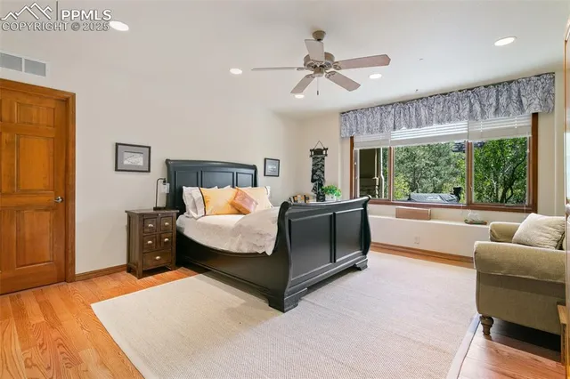 a bedroom with furniture and a large window