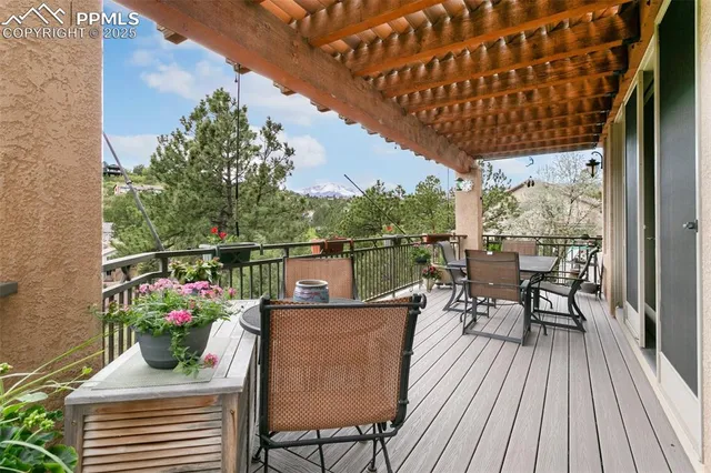 a view of a balcony with chairs and wooden floor