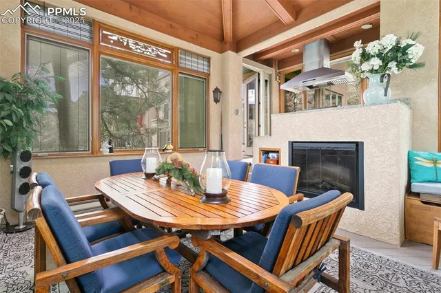 a view of a patio with a dining table and chairs