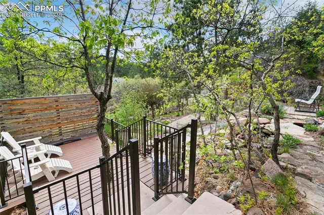 a view of a balcony with wooden floor and fence