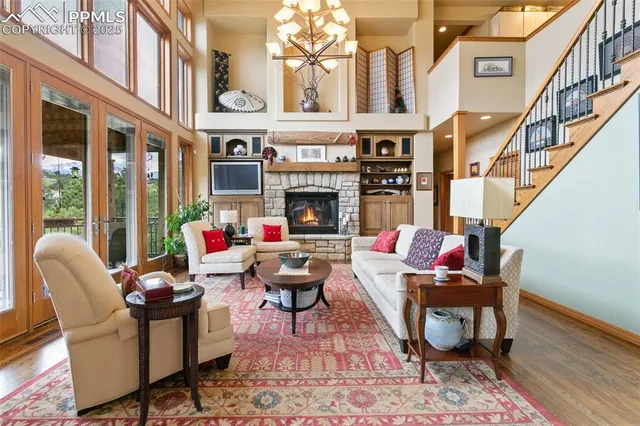 a living room with fireplace furniture and a floor to ceiling window