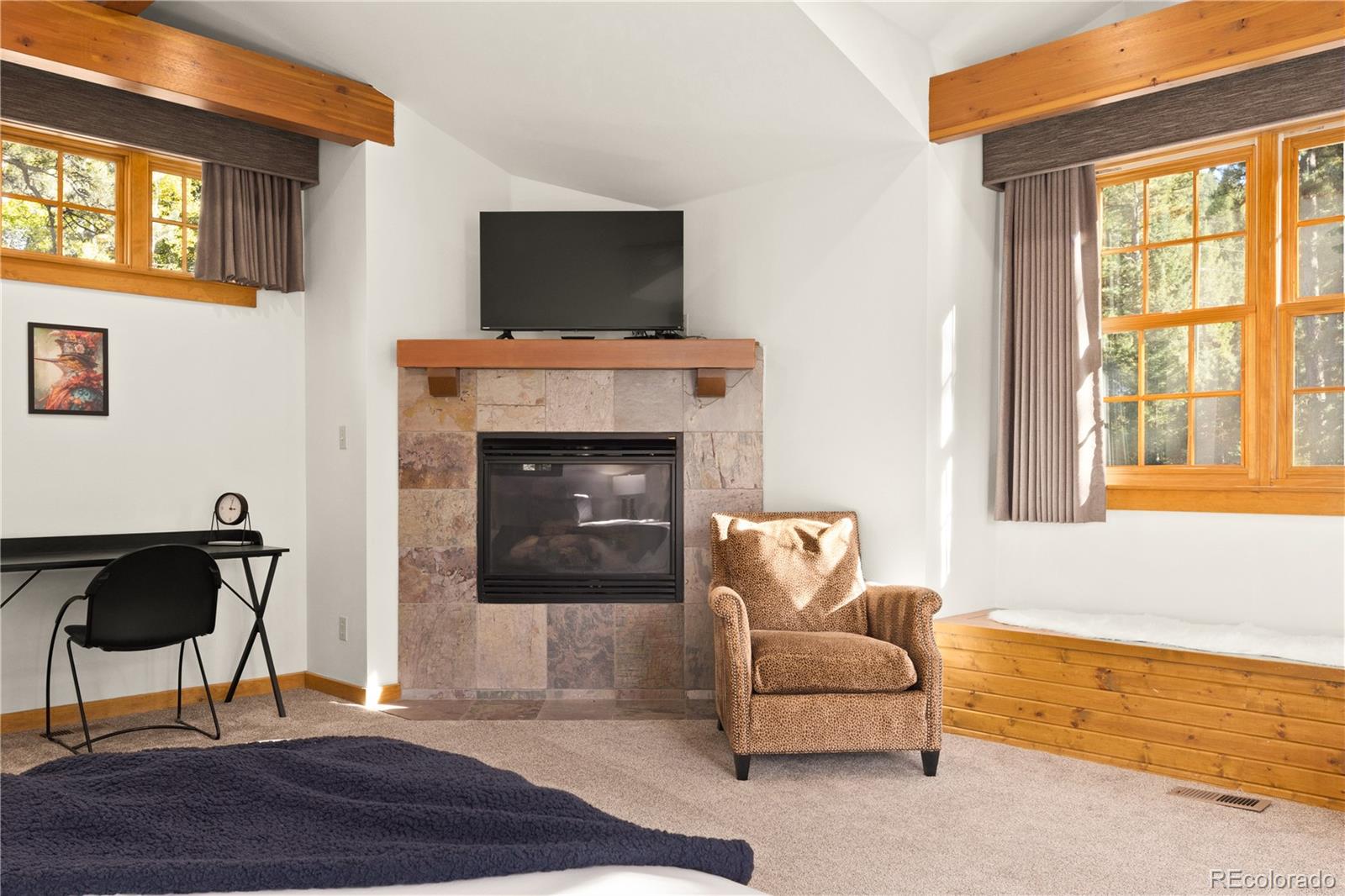 32217 Buffalo Park Road Evergreen, CO 80439 - Photo 11 of 46 a living room with furniture and a fireplace