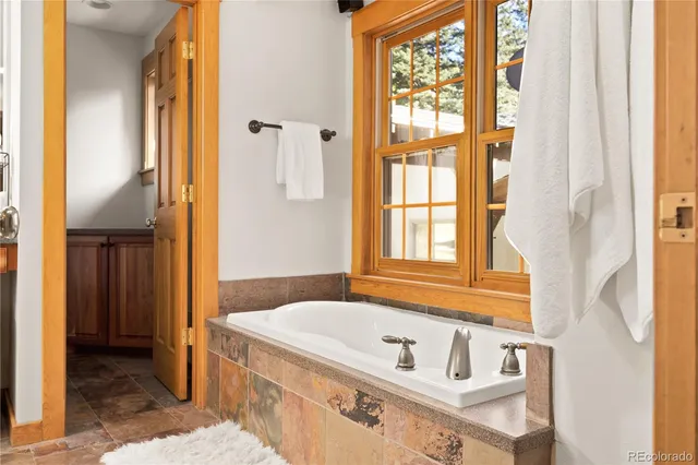 a bathroom with a tub and a window