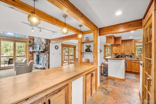 a kitchen with stainless steel appliances kitchen island granite countertop a refrigerator and stove