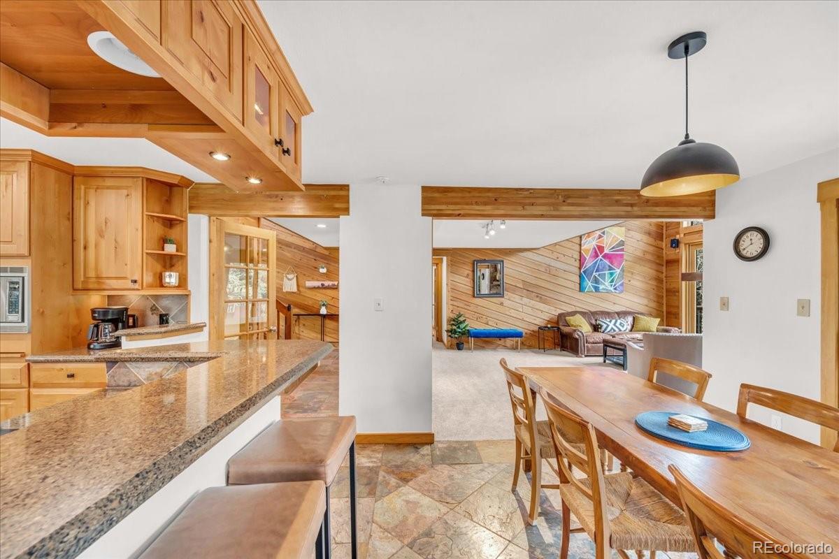 32217 Buffalo Park Road Evergreen, CO 80439 - Photo 17 of 46 a view of a living room and dining area with furniture