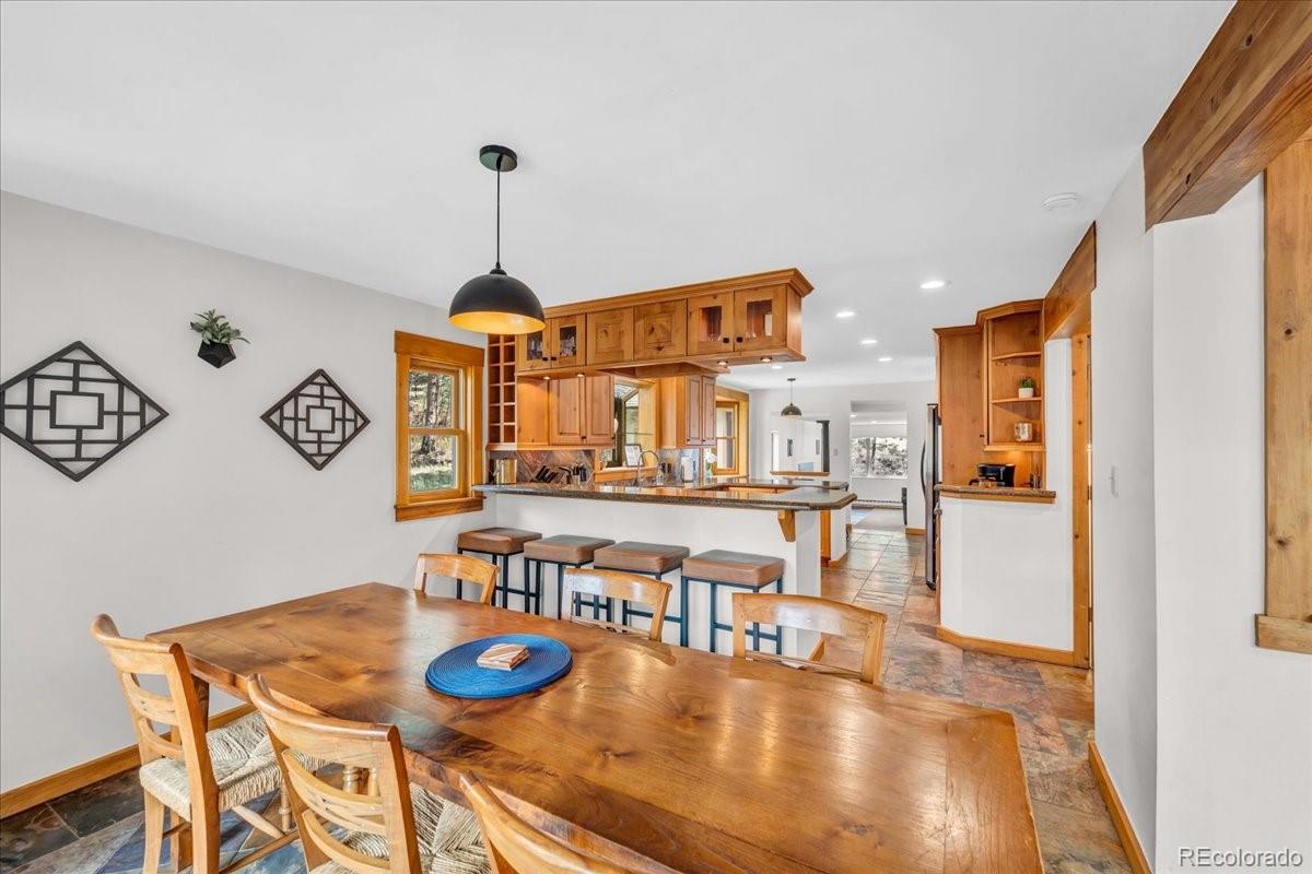 32217 Buffalo Park Road Evergreen, CO 80439 - Photo 18 of 46 a dining room with furniture and wooden floor