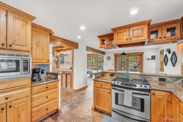 a kitchen with stainless steel appliances granite countertop a stove and a sink