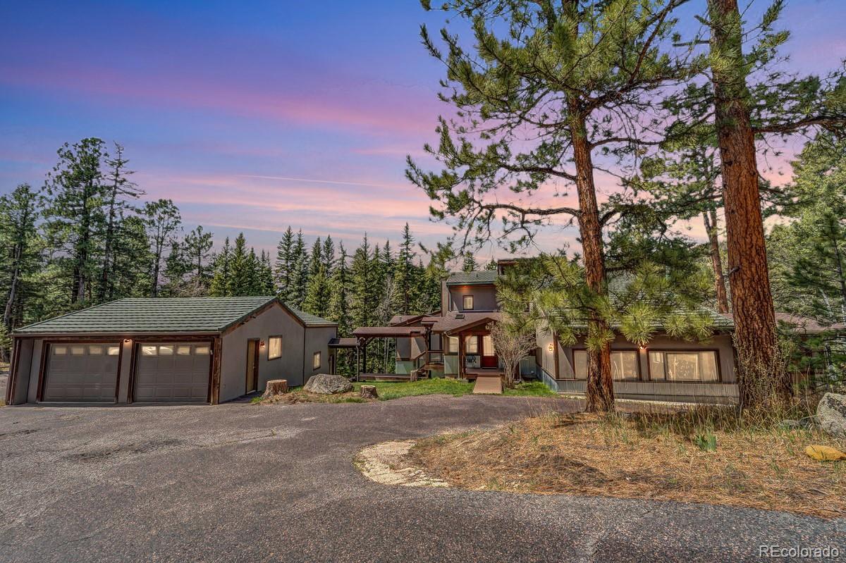 32217 Buffalo Park Road Evergreen, CO 80439 - Photo 2 of 46 a front view of a house with a yard and tree s