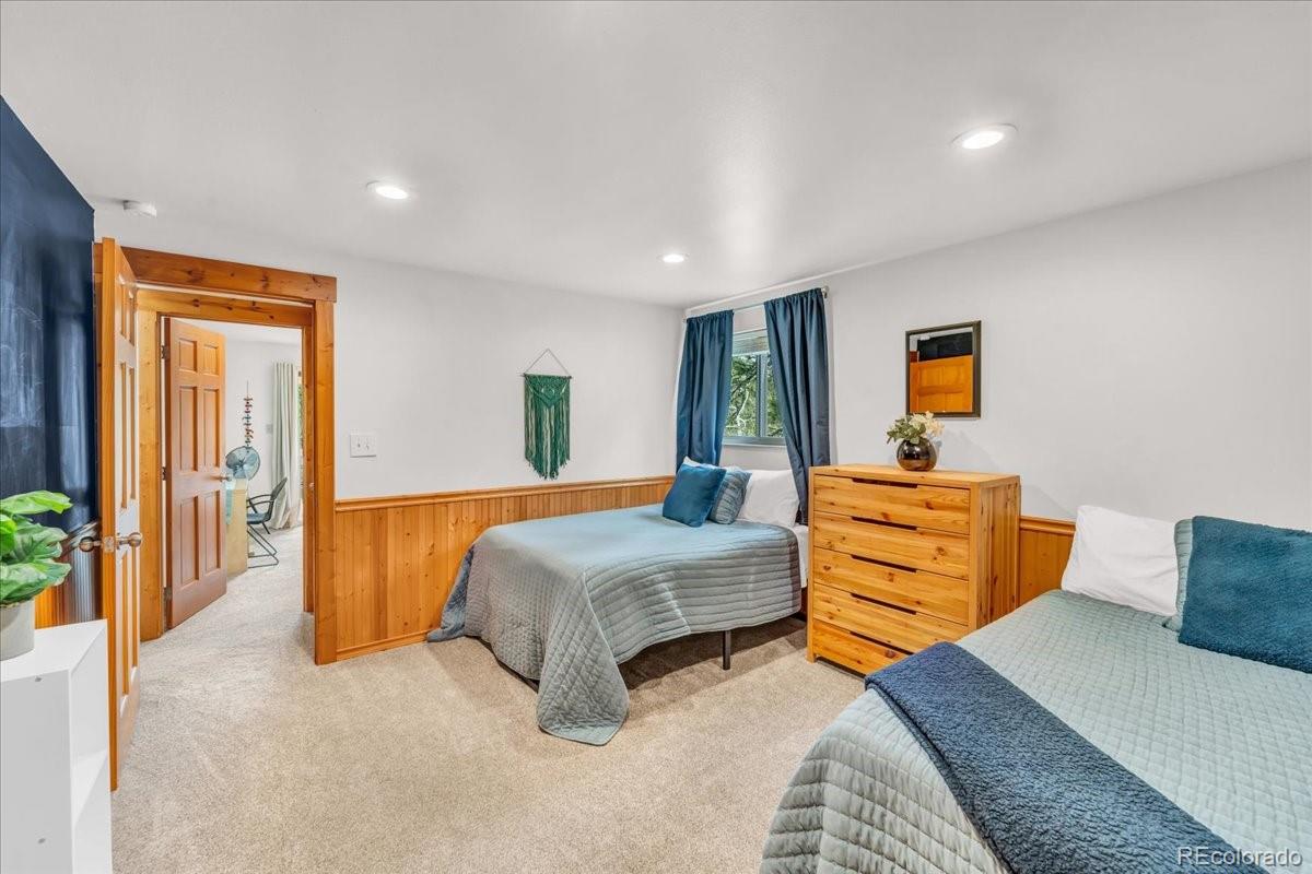 32217 Buffalo Park Road Evergreen, CO 80439 - Photo 26 of 46 a bedroom with a bed and lamp