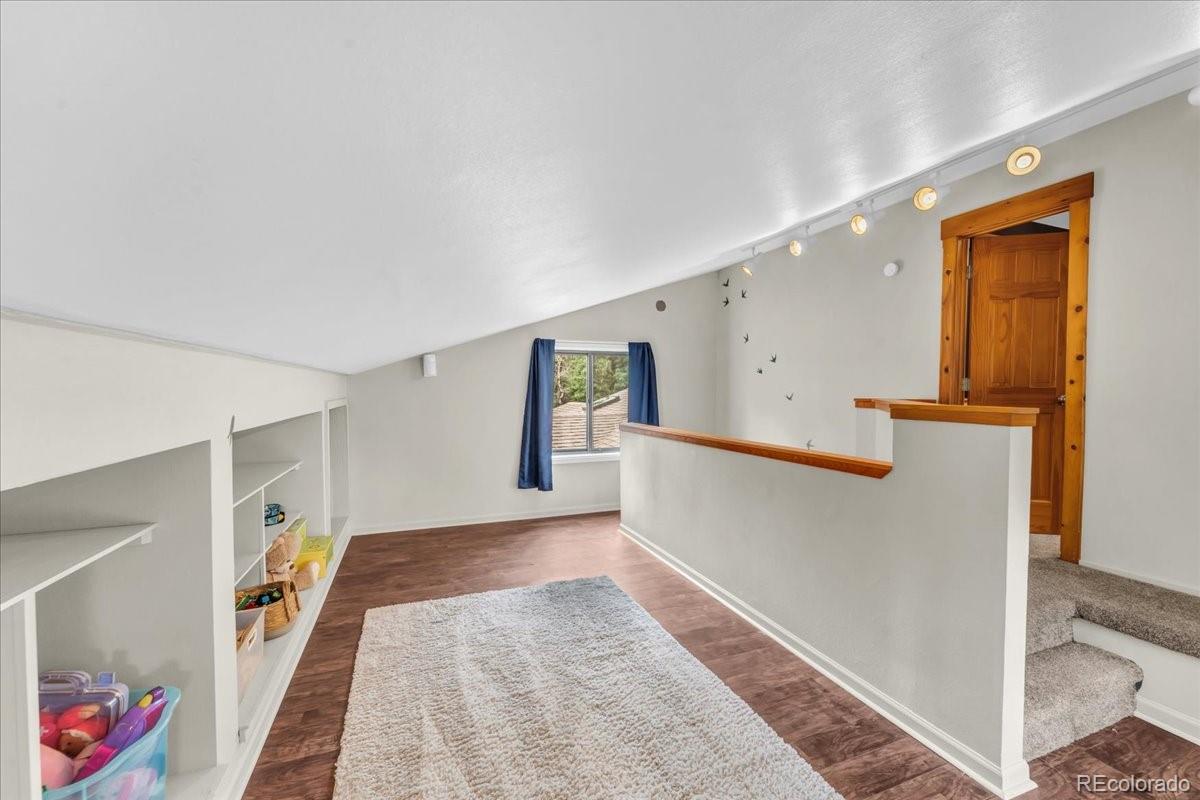 32217 Buffalo Park Road Evergreen, CO 80439 - Photo 32 of 46 a view of hallway with stairs and wooden floor