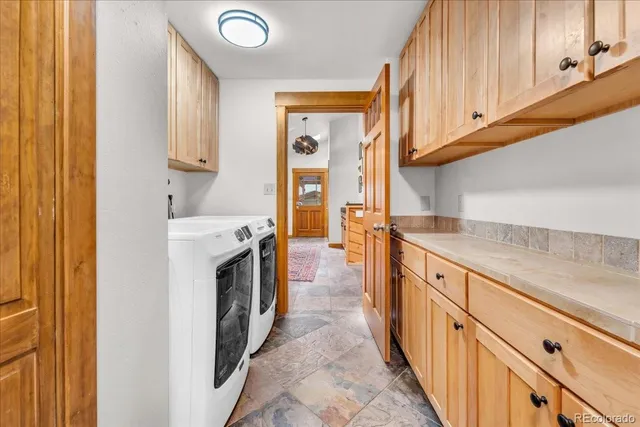 a kitchen with stainless steel appliances granite countertop a refrigerator and a stove