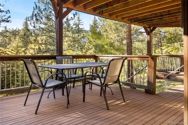 a view of a chairs and table on the deck