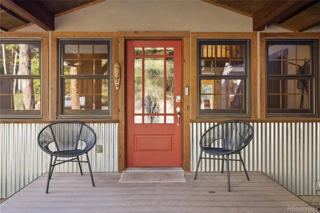 a view of front door with chair and table