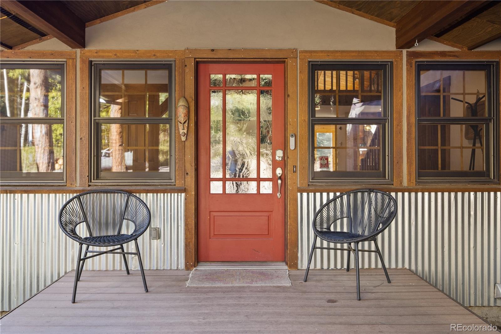 32217 Buffalo Park Road Evergreen, CO 80439 - Photo 42 of 46 a view of front door with chair and table