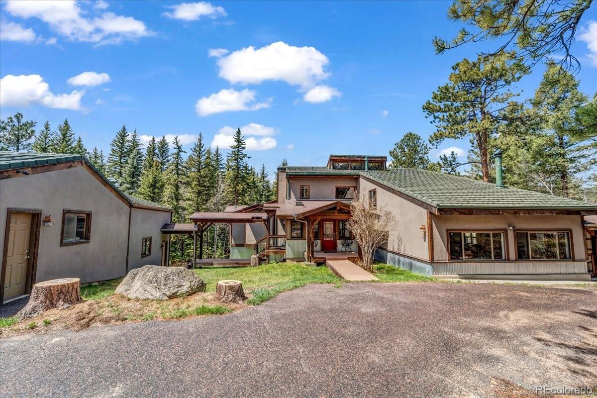 32217 Buffalo Park Road Evergreen, CO 80439 - Photo 46 of 46 a front view of a house with a yard and garage