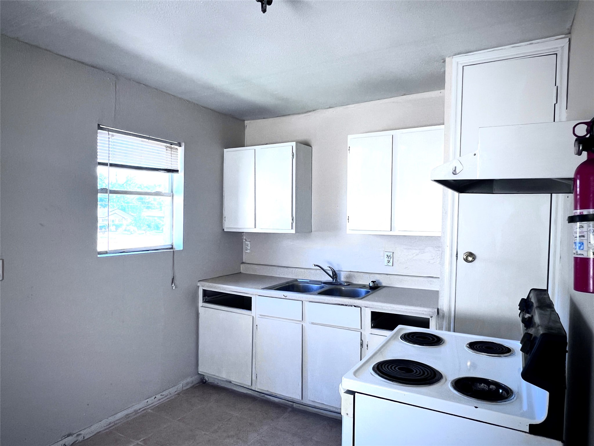 6802 Sayers Street, Unit A FEW Houston, TX 77016 - Photo 13 of 32 a kitchen with a white stove top oven and sink