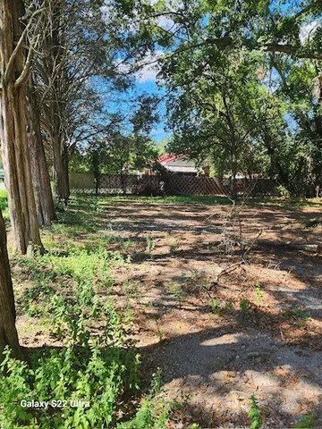 a backyard of a house with lots of green space and lake view