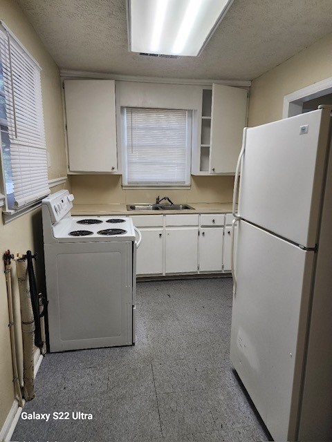 2443 South Lumpkin Road Columbus, GA 31903 - Photo 3 of 13 a kitchen with cabinets a refrigerator and a sink
