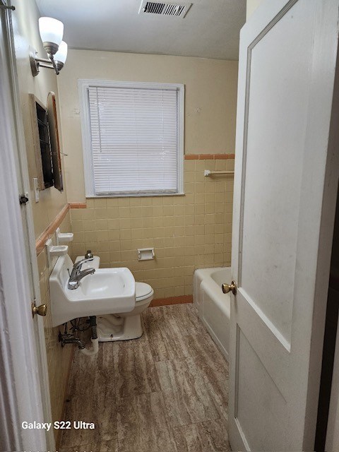2443 South Lumpkin Road Columbus, GA 31903 - Photo 7 of 13 a bathroom with a sink a toilet and mirror