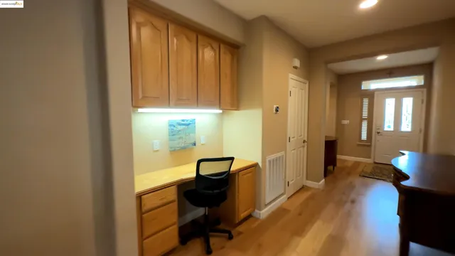 a view of a workspace with furniture and wooden floor