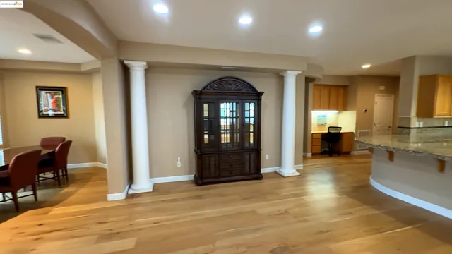 a view of a living room kitchen and a wooden floor