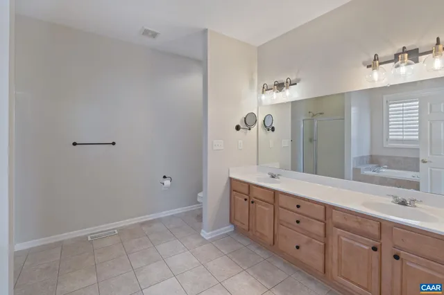 a view of walk in closet with clothes