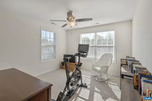 a living room with furniture a rug and a window