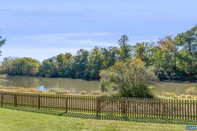 an aerial view of a house with a lake