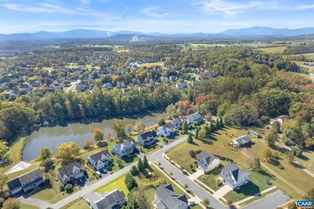 a view of a white house with a yard