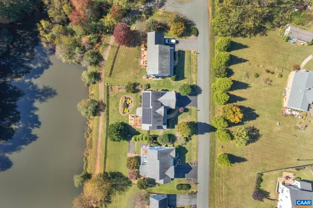 a front view of a house with swimming pool having outdoor seating