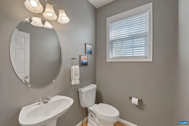 a dining hall with stainless steel appliances granite countertop a table chairs and a refrigerator