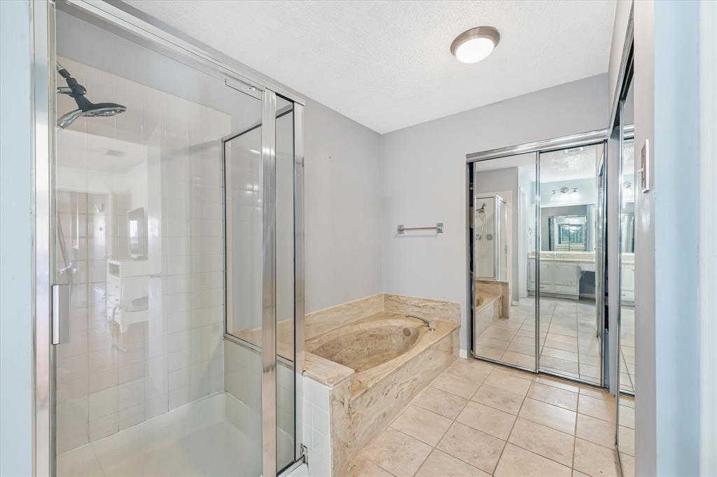 1301 Memory Lane, Unit 4924 Arlington, TX 76011 - Photo 14 of 19 Bathroom featuring a garden tub, a shower stall, tile patterned flooring, and a textured ceiling
