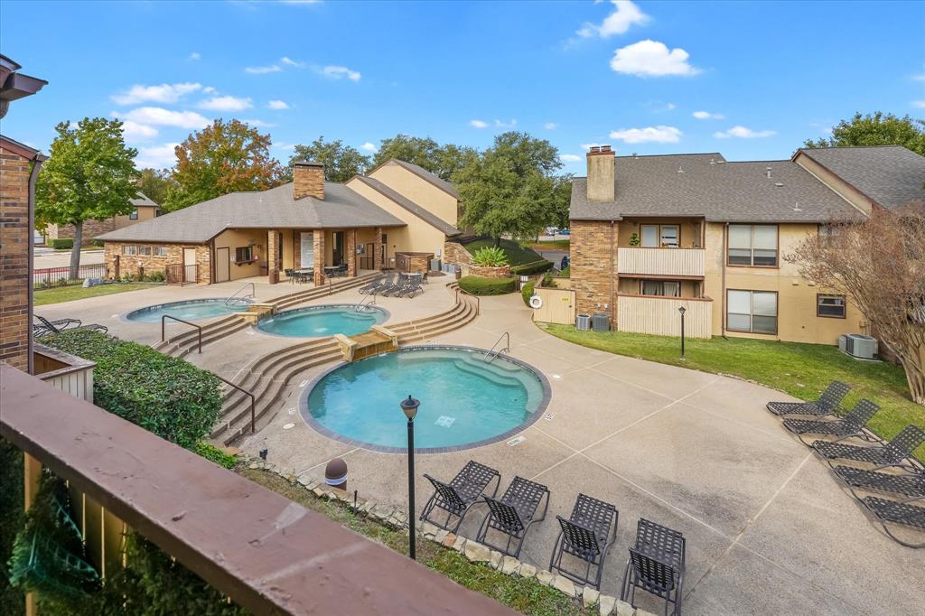 1301 Memory Lane, Unit 4924 Arlington, TX 76011 - Photo 16 of 19 Community pool featuring a patio and a hot tub