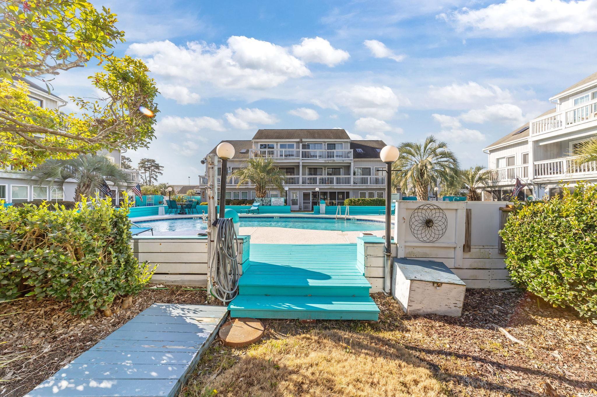 3700 Golf Colony Lane, Unit 2I Little River, SC 29566 - Photo 17 of 23 Surrounding community with a swimming pool and a patio area