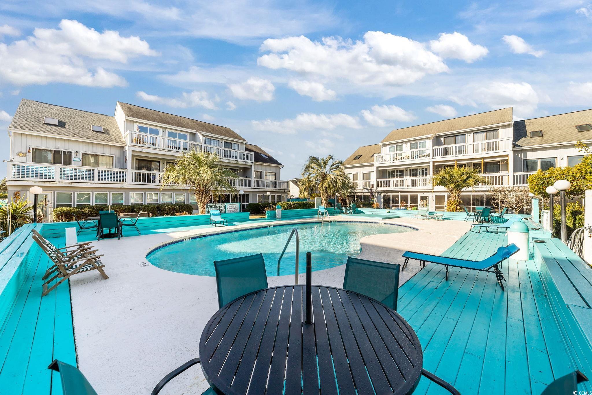 3700 Golf Colony Lane, Unit 2I Little River, SC 29566 - Photo 18 of 23 Community pool with a patio area