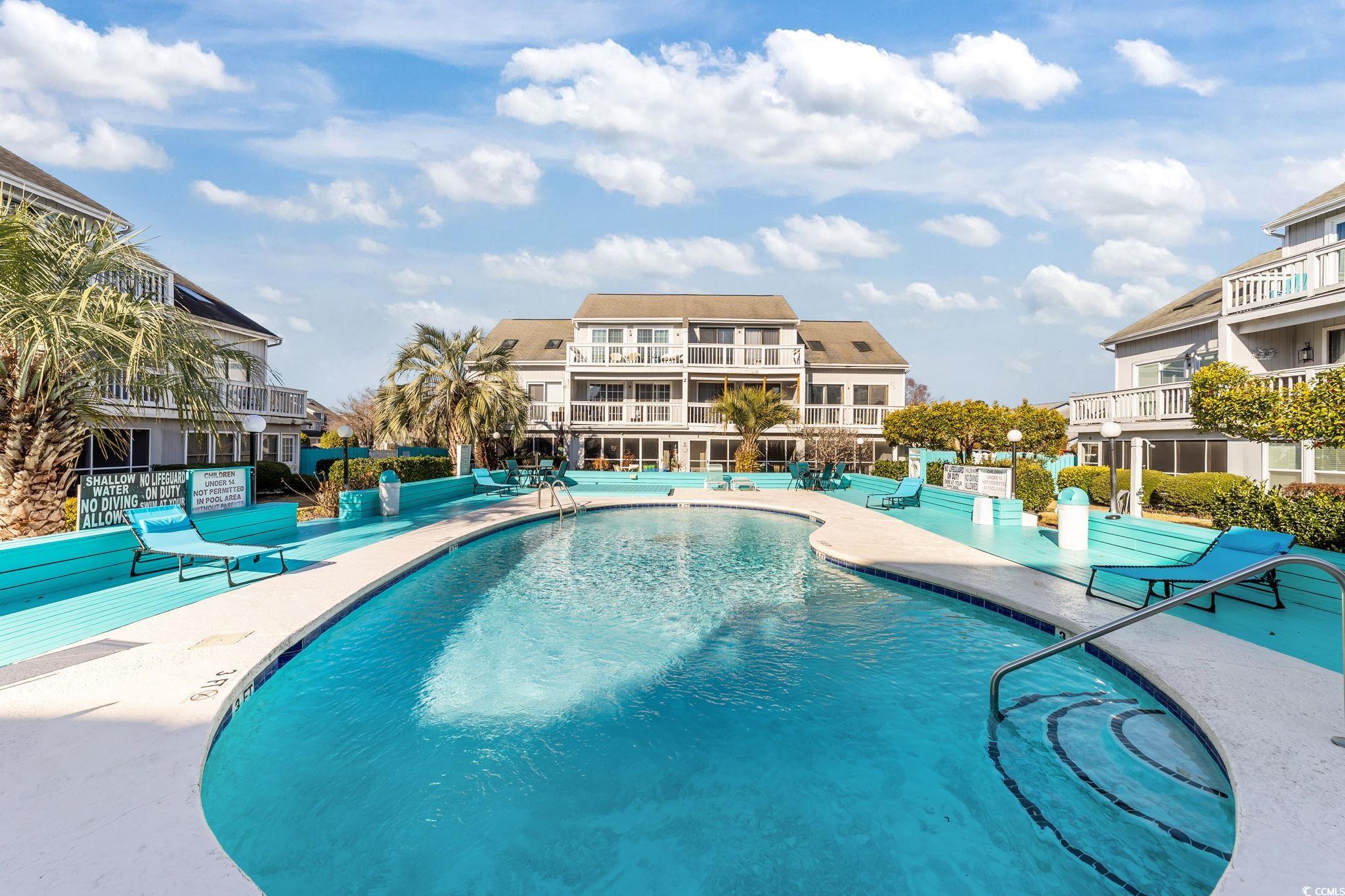 3700 Golf Colony Lane, Unit 2I Little River, SC 29566 - Photo 19 of 23 Community pool with a patio and a balcony