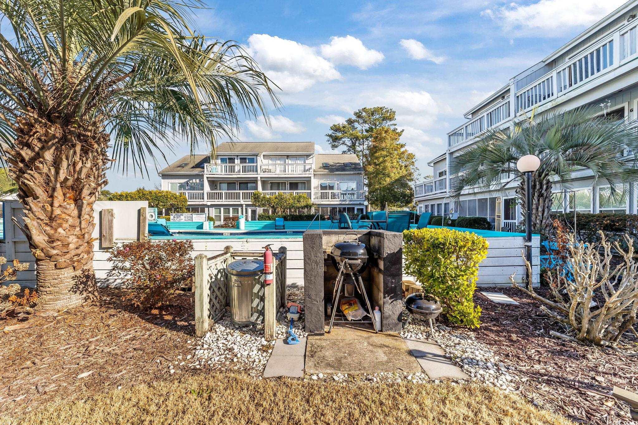 3700 Golf Colony Lane, Unit 2I Little River, SC 29566 - Photo 20 of 23 Community pool featuring a patio area