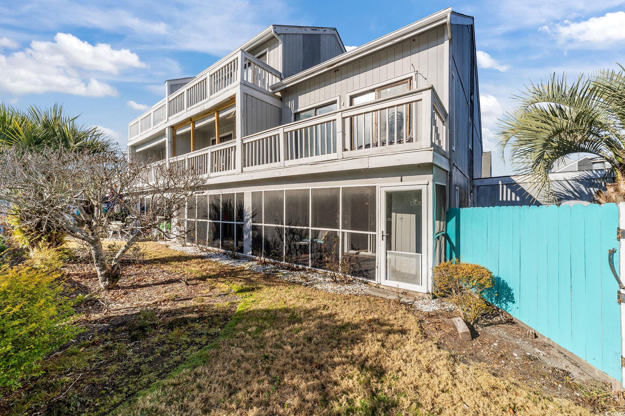 3700 Golf Colony Lane, Unit 2I Little River, SC 29566 - Photo 21 of 23 Back of property featuring a sunroom and a balcony