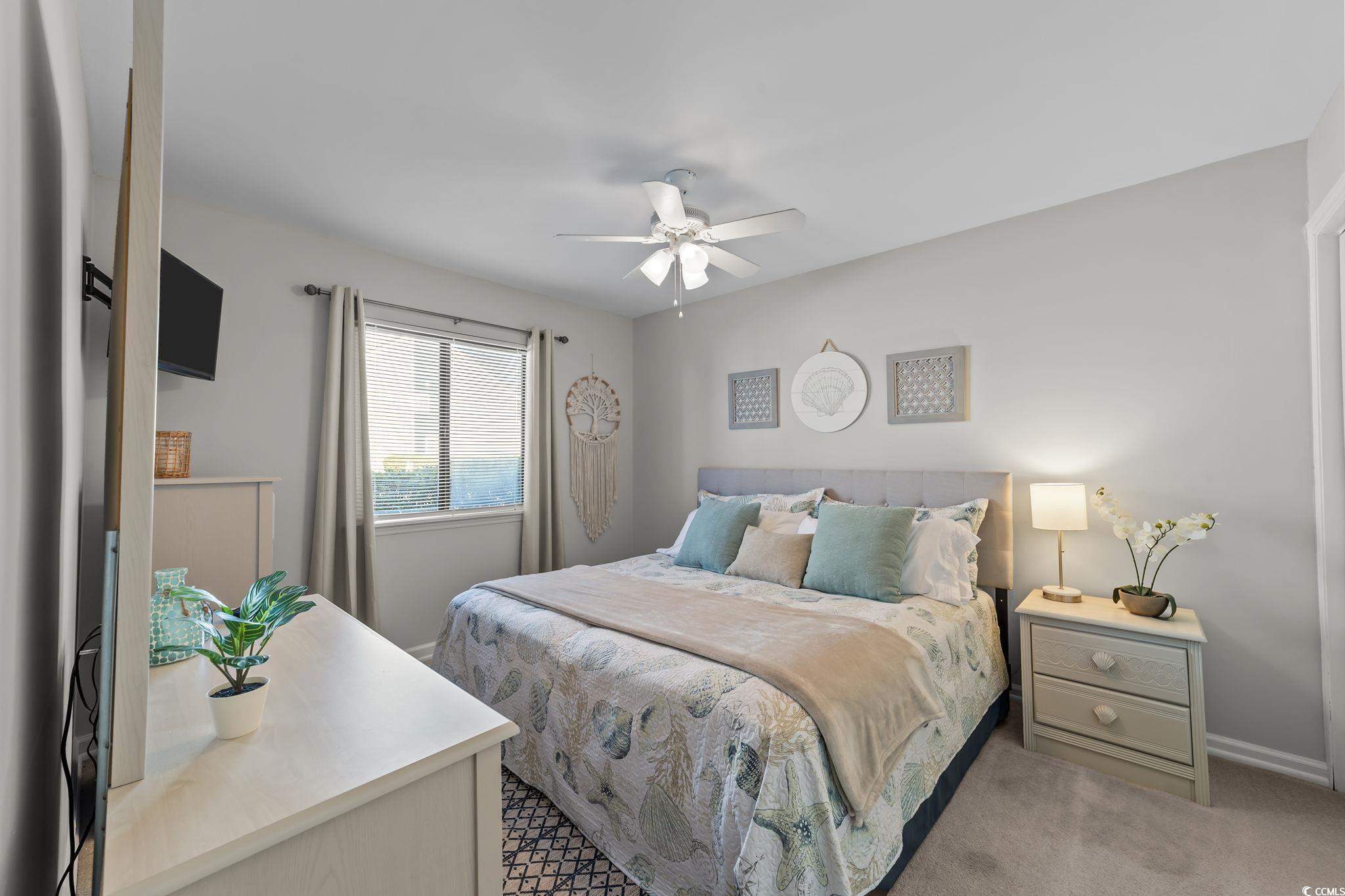 3700 Golf Colony Lane, Unit 2I Little River, SC 29566 - Photo 4 of 23 Bedroom featuring light carpet and a ceiling fan