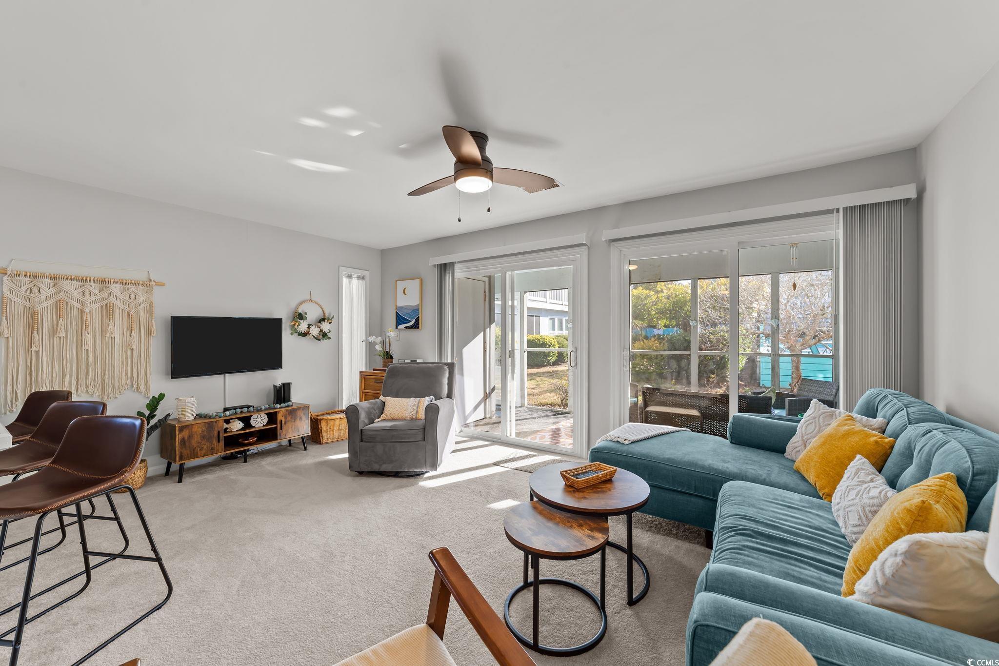 3700 Golf Colony Lane, Unit 2I Little River, SC 29566 - Photo 9 of 23 Living room with a ceiling fan and carpet floors