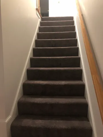 a view of staircase with white walls