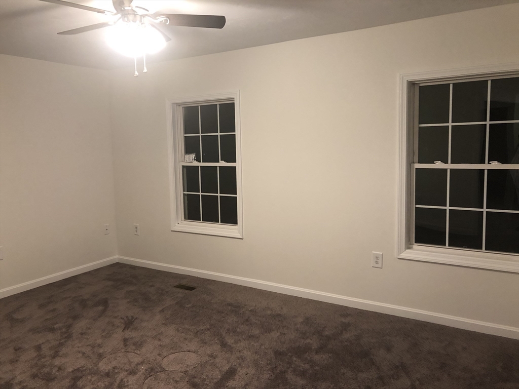 41 Boston Road, Unit 174 Billerica, MA 01862 - Photo 5 of 9 an empty room with windows and fan