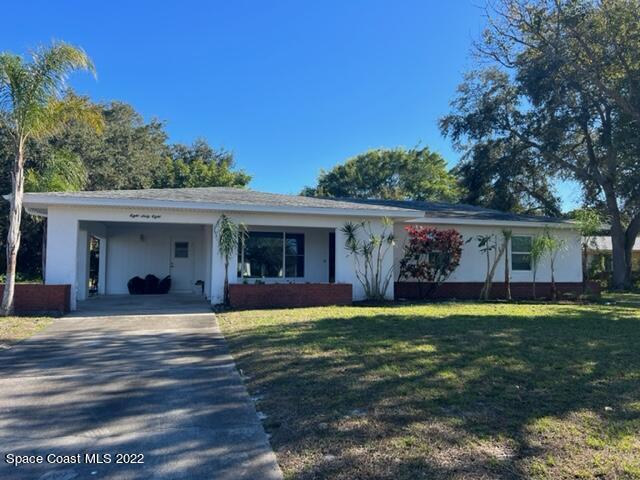 a view of a house with a yard porch and furniture